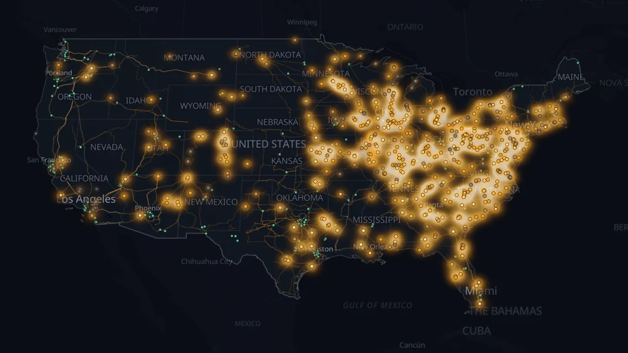 Voltane Nuclear map: candidate sites across the United States glowing amber by score, with transmission lines and data centers.